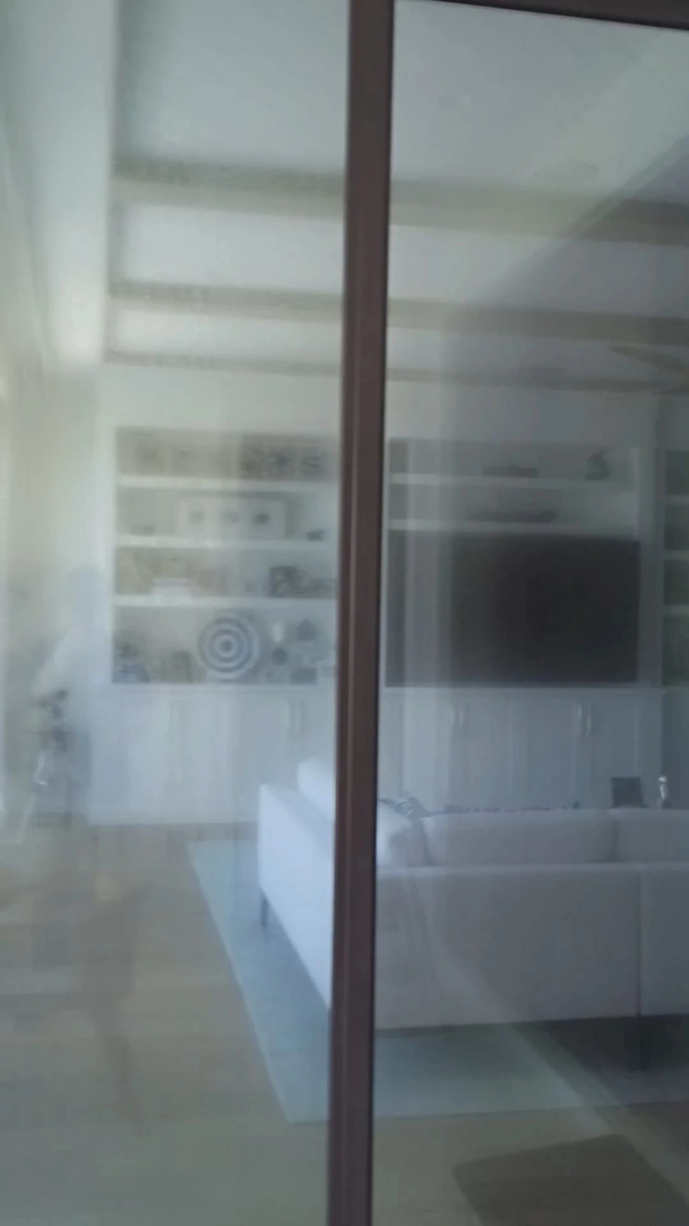 Hazy, salt-filmed sliding glass door before professional cleaning, San Clemente, CA